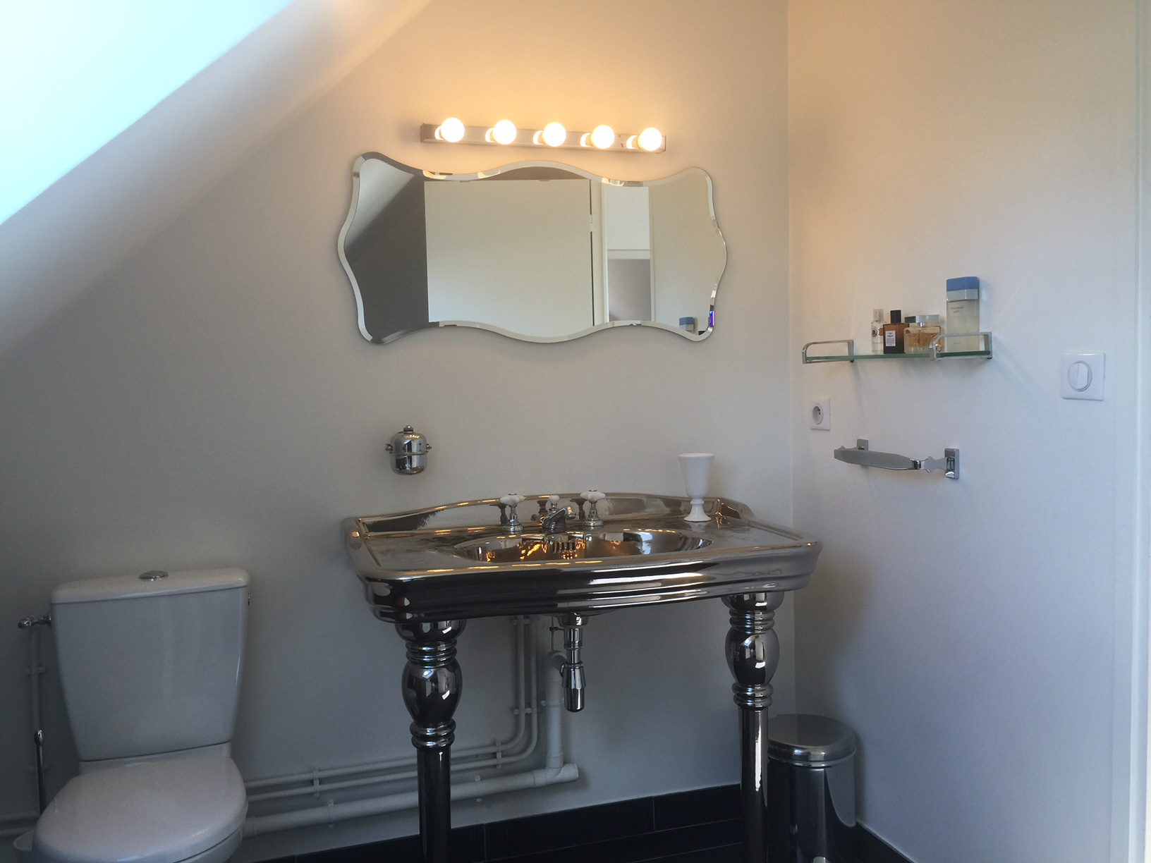 Salle de bains à Montreuil avec lavabo sur pied en métal chromé et miroir aux courbes rétro