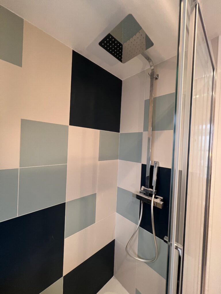 Douche contemporaine avec colle de douche externe design et carrelage mural graphique